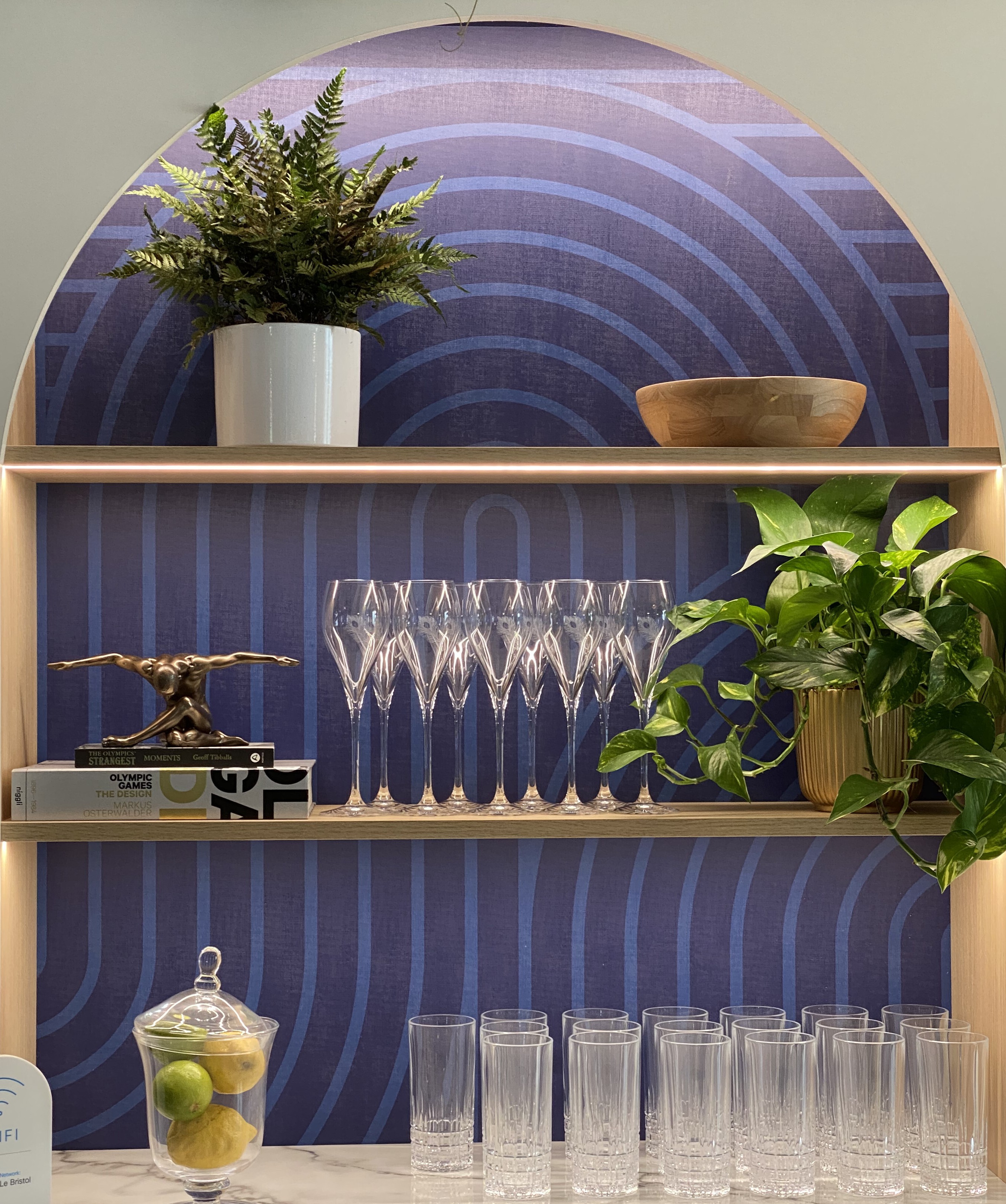 Arched shelf display with cups and plants